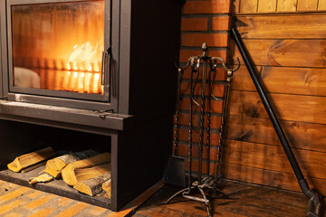 home fireplace. cozy interior of a country house. vintage stone fireplace in the room. a warm flame...