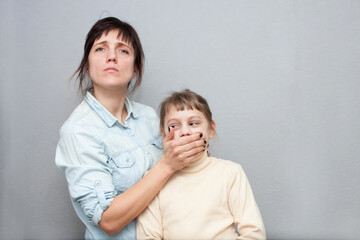 Distraught 30s mother   closing  her child's mouth