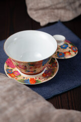 Beautiful cup with dried tea rose flowers