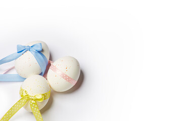 Minimal easter style design concept with three creative dotted eggs with the colored ribbons isolated on the white background