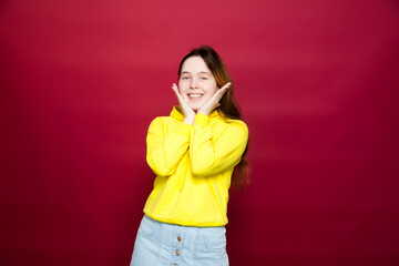 16-year-old girl in  denim skirt  with loose wavy long hair.