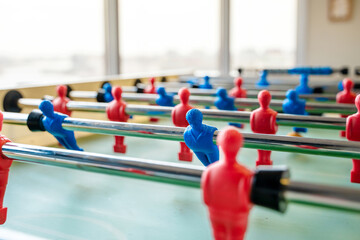 Kicker table for table football with blue and red players