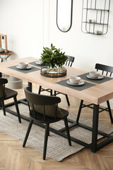 Stylish wooden dining table and chairs in room. Interior design