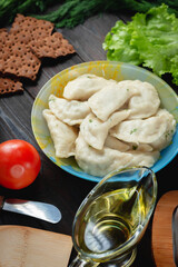 homemade natural farm dumplings and dumplings on the table with vegetables and herbs.