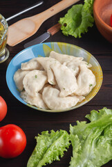 homemade natural farm dumplings and dumplings on the table with vegetables and herbs.