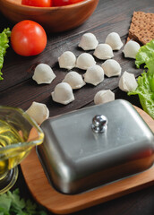 homemade natural farm dumplings and dumplings on the table with vegetables and herbs.