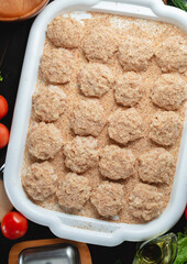 homemade natural farm cutlets on the table with vegetables and herbs.