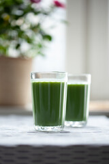 Pineapple, kiwi amd mint green smoothie on table. 