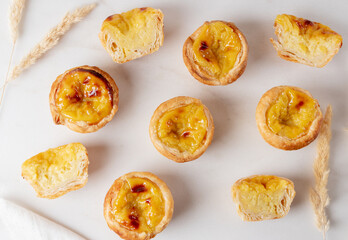 Pastel de Nata - portugese egg custard pies on white background, copy space.