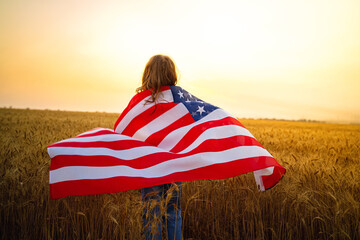 Adorable patriotic girl wearing an American flag in a beautiful