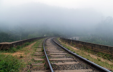 Fototapeta na wymiar Landscape mountain railway bridge. Perspective View Metal rail road path