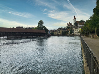 Thun, Switzerland. Image of the city of Thun with the castle and the wooden bridge, taken along the Aare river