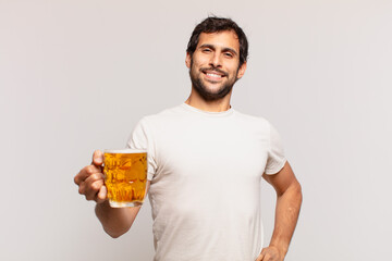 young handsome indian man happy expression and holding a beer