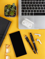 Cell phone and modern gadgets on a yellow background top view