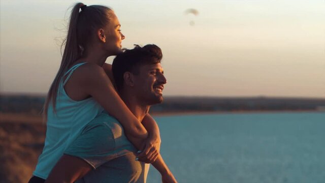 The happy couple standing near the ocean. slow motion