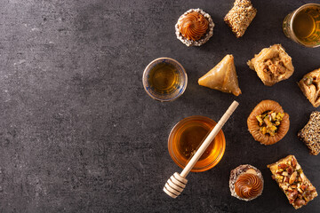 Assortment of Ramadan dessert baklava on black background. Top view. Copy space. traditional arabic sweets