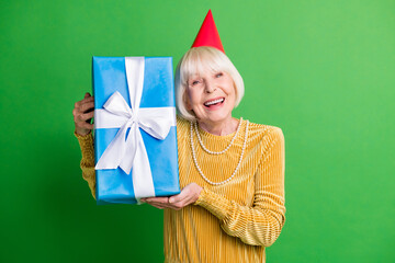 Photo of retired lady hold present box wear red cone cap yellow velvet shirt pearl necklace...