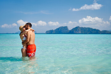 Romantic couple kissing on paradise tropical beach with copy space