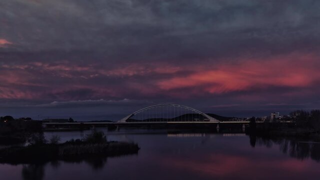Timelapse Sunset with stunning red skies over the Lusitania bridge of architect Santiago Calatrava