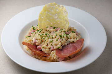 Pastasotto recipe with shells and ham, ham and cheese tiles, High quality photo