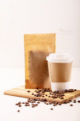 Take away paper cup of coffee and blank coffee packs