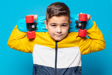 little boy happy expression and holding a skateboard