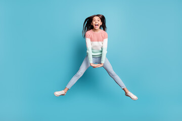 Full length photo of young preteen girl happy positive smile active energetic jump up isolated over blue color background