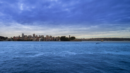 Sydney Harbour forshore viewed from the Gardens in NSW Australia on a nice sunny and partly cloudy Morning blue skies