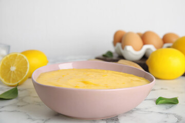 Delicious lemon curd on white marble table