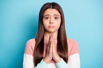 Photo of young schoolgirl unhappy sad upset ask beg wish want expect isolated over blue color...