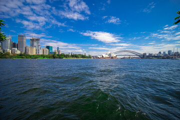 Obraz premium Sydney Harbour forshore viewed from the Gardens in NSW Australia on a nice sunny and partly cloudy Morning blue skies