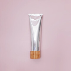 Metal tube of natural toothpaste on pink