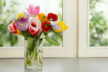 Beautiful spring flowers on window sill indoors