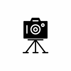 Camera icon with tripod in glyph style. Vector