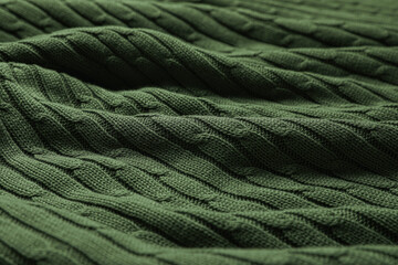 Dark green knitted wool texture as background, closeup