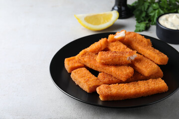 Fresh breaded fish fingers served on white table, space for text