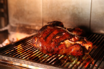 Grilling grate with pork foreshanks in oven