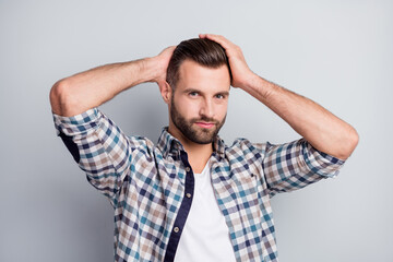 Portrait of attractive content guy wear checked shirt caressing new hairdress isolated over gray pastel color background