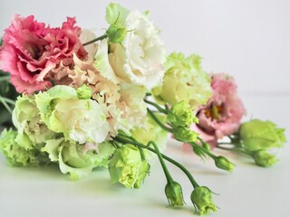 Beautiful Bouquet of eustoma flowers. Greeting wedding or summer card. Lisianthus flowers close-up with soft sunlight for flower poster, wallpaper or holiday card. Spring banner