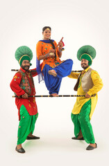 Two Bhangra and one Giddha Dancer with Khunda and Tumbi depicting a dance step.