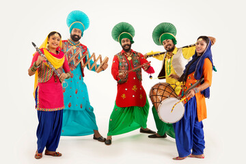 A Troupe of Punjabi Folk dancers dressed in costume with Dhol,Khunda,Alghoza,Saap and Chimta.	