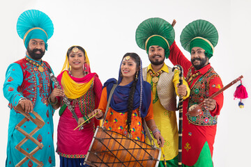 A Troupe of Punjabi Folk dancers dressed in costume with Dhol,Khunda,Alghoza,Saap and Chimta.	