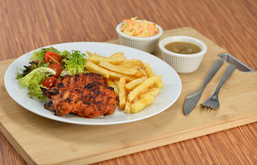 delicious plate of western food chicken chop with fries and salad