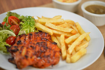 delicious plate of western food chicken chop with fries and salad