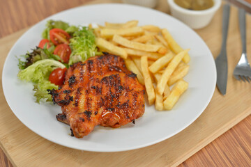 delicious plate of western food chicken chop with fries and salad