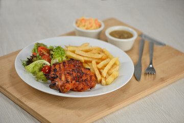 delicious plate of western food chicken chop with fries and salad