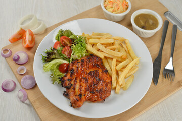 delicious plate of western food chicken chop with fries and salad