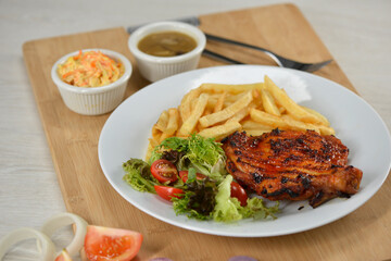 delicious plate of western food chicken chop with fries and salad