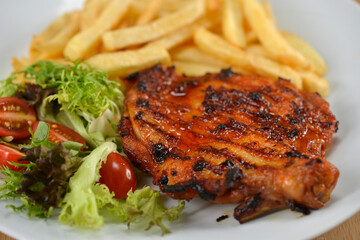 delicious plate of western food chicken chop with fries and salad