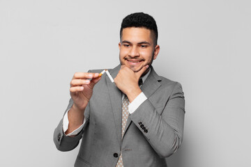 hispanic businessman happy expression. quitting smoking concept